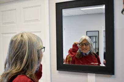 Cheri trying on glasses at TCCH Fellsmere