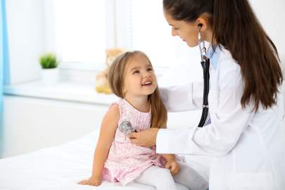 Pediatrician with her young patient